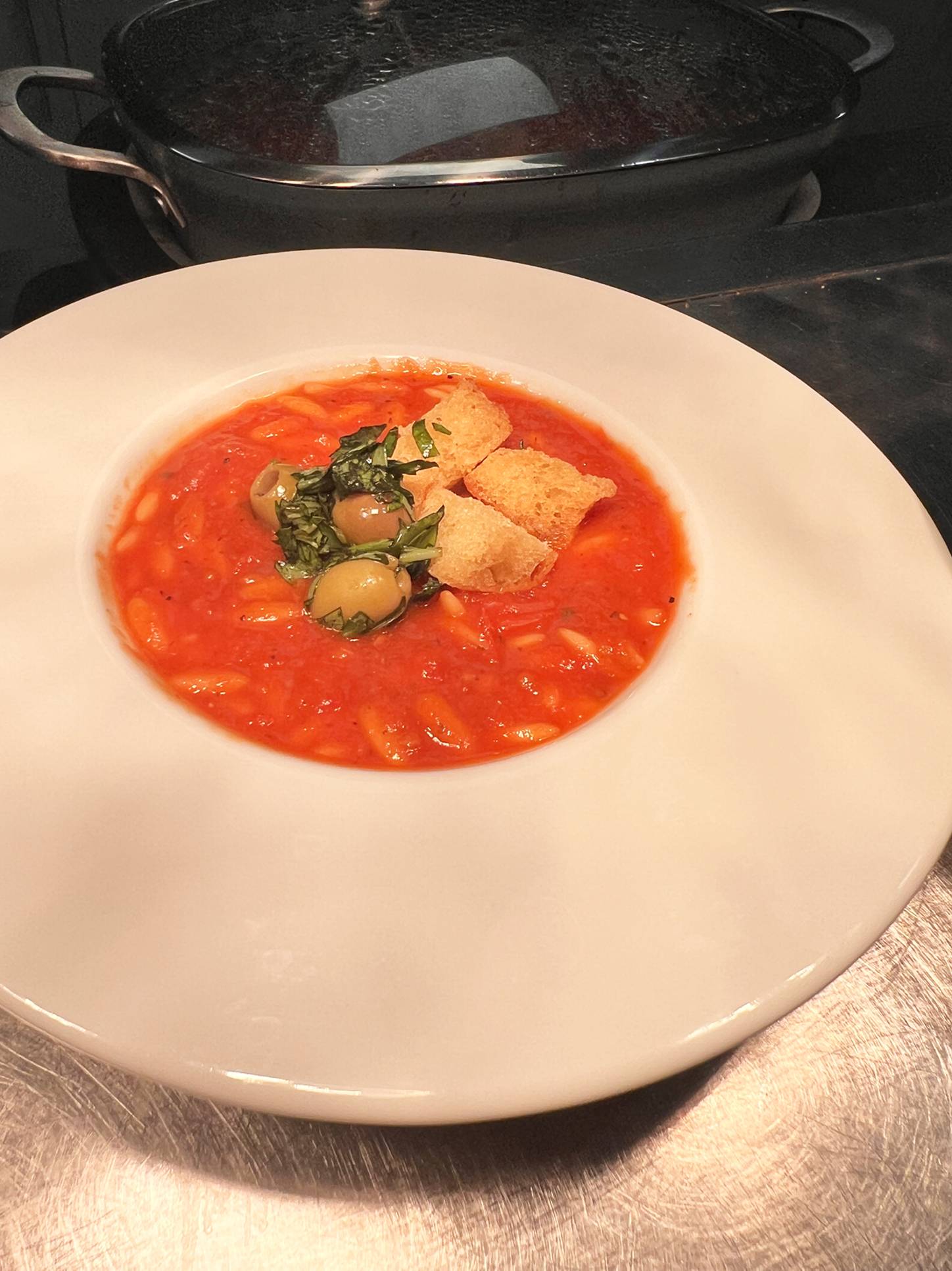Italian roasted tomato with orzo & black olive soup